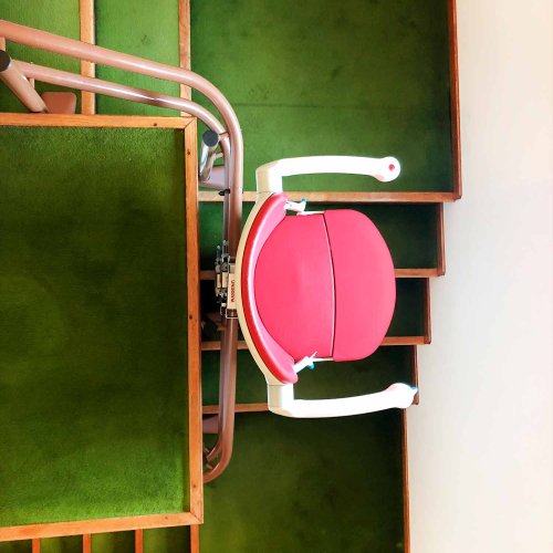 Montascale a poltroncina per pavimento in moquette - due tubi color rubino - Montebelluna